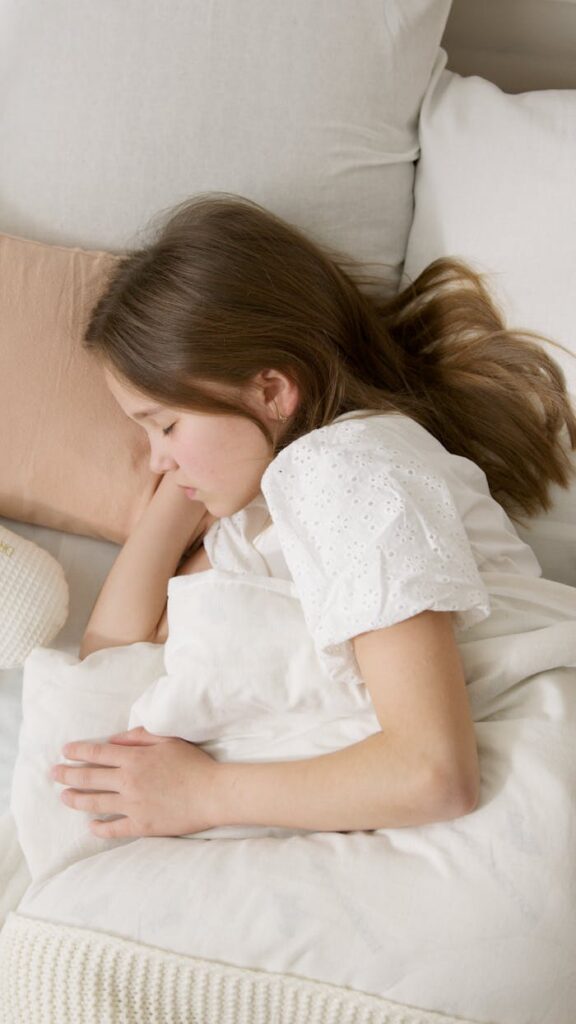 A young caucasian girl sleeping peacefully indoors, capturing a serene and relaxing atmosphere.